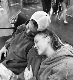 Black and white photo of a couple cuddling.