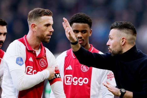 Francesco Farioli applauding at an Ajax Amsterdam soccer match.