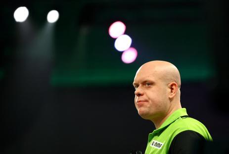 Michael van Gerwen looking dejected during a darts match.