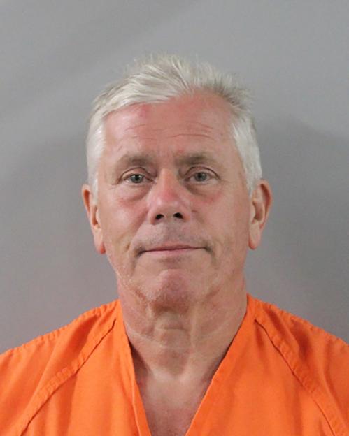Mugshot of Mark Gibbon, wearing an orange jumpsuit.