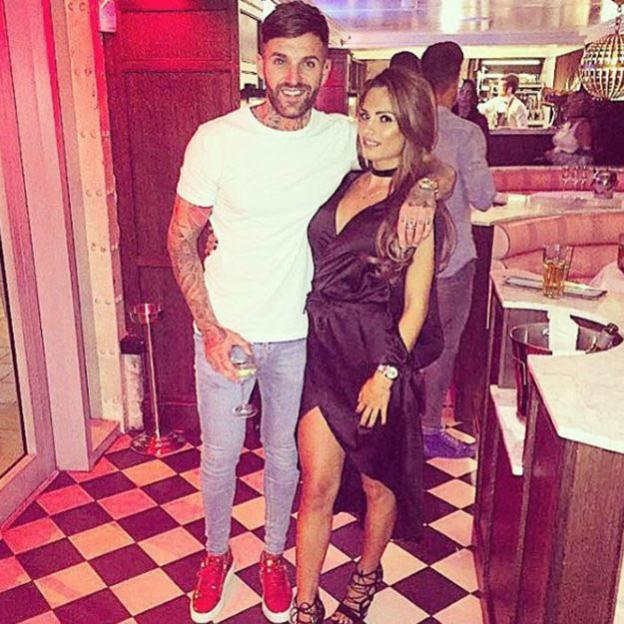 Aaron Chalmers and Nicole Bass posing together.