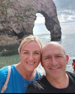 Couple smiling for a selfie at Durdle Door.