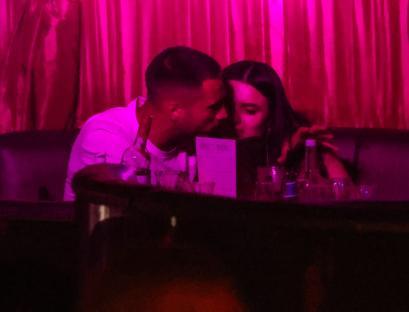 Ron Hall canoodling with a mystery brunette at a London cabaret.