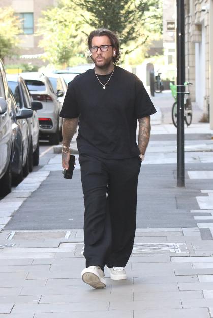 Pete Wicks walking down a street.