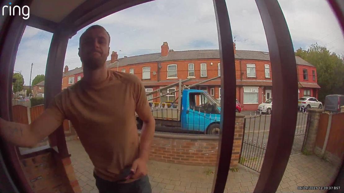 Ring doorbell camera footage of a man at a house with scaffolding being unloaded from a truck.