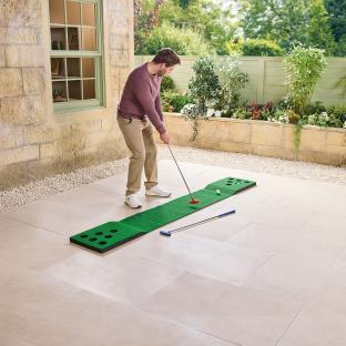 Man using a putting green set.