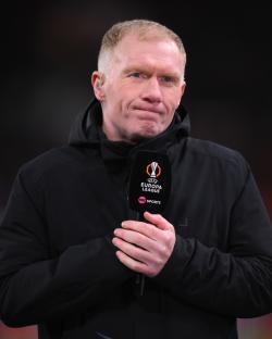 Paul Scholes holding a TNT Sports microphone during a UEFA Europa League match.