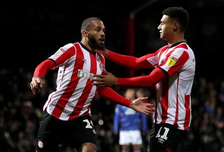 Two Brentford soccer players celebrating a goal.