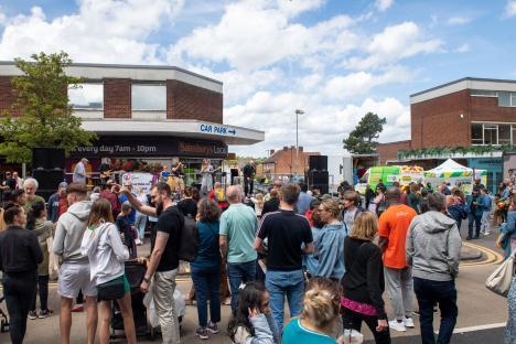 Crowd enjoying a sunny day at an outdoor festival.