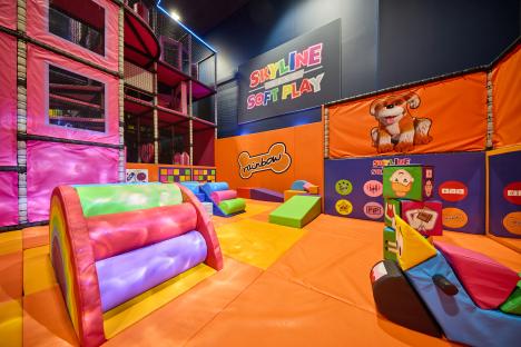 Indoor soft play area with colorful equipment.