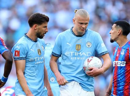 Manchester City's Ruben Dias and Erling Haaland after a penalty.