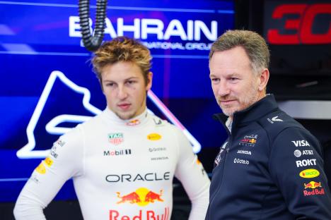 Christian Horner and Liam Lawson of Oracle Red Bull Racing in the garage.