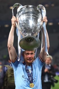 Kevin De Bruyne of Manchester City holding the UEFA Champions League trophy.