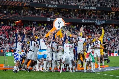 Tottenham Hotspur players celebrating with the UEFA Europa League trophy.