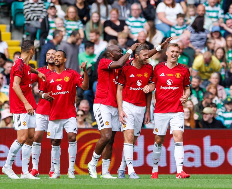 Manchester United Legends celebrating a goal.