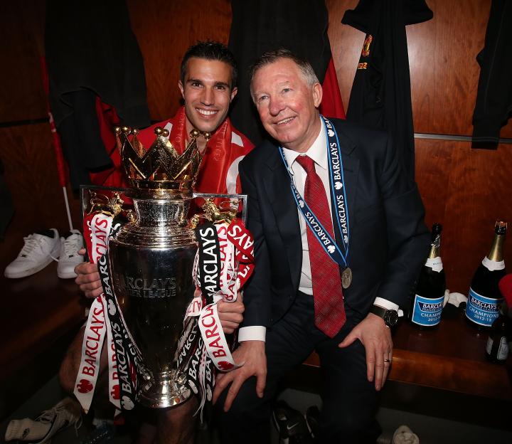 Robin van Persie and Sir Alex Ferguson celebrating with the Barclays Premier League trophy.