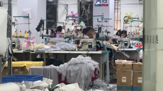 Factory workers operating sewing machines in a Shein factory.