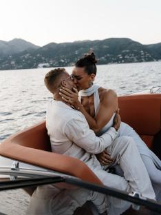 Couple kissing on a boat.