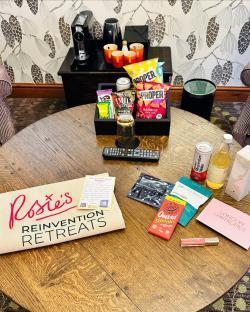 Hotel room amenities including snacks, drinks, and a welcome bag.