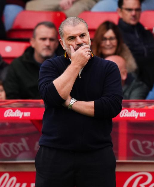 Nottingham Forest head coach Ange Postecoglou, with his hand on his chin, looking concerned.