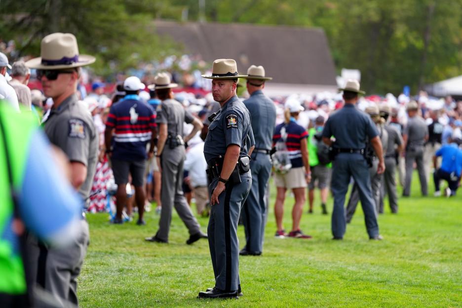 Police officer in uniform at a golf course.