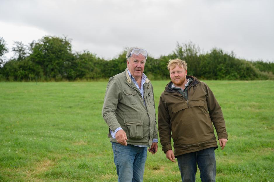 Jeremy Clarkson and a younger man standing in a field.