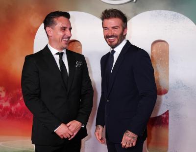 Photo of David Beckham and Gary Neville in suits.