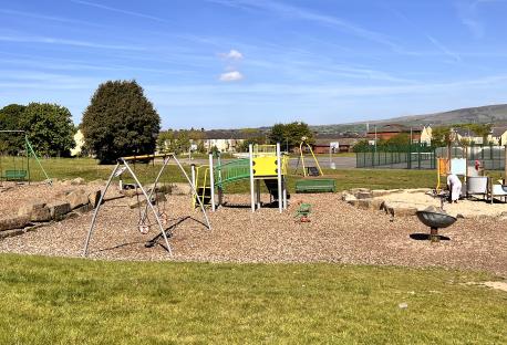 Playground with swings, slides, and other play equipment.