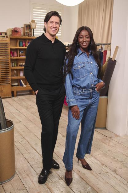 Two people standing in a workshop.