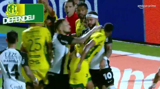 Soccer players in a scrum after a missed penalty kick.