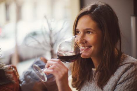 Woman enjoying a glass of red wine.