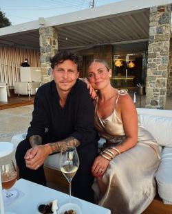 Couple sitting together outdoors at a resort.