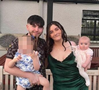 Photo of a young couple with two babies.