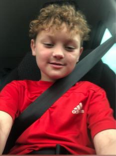 Weston Kiesler, an eight-year-old boy, in a red shirt.