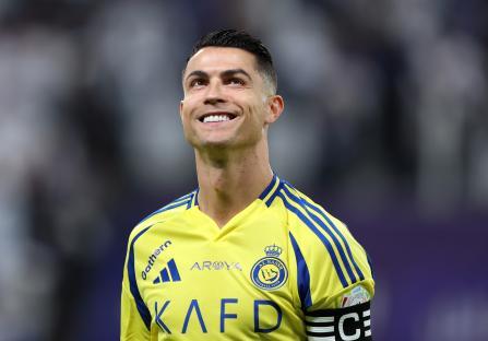 Cristiano Ronaldo of Al Nassr looking up during a soccer match warm-up.