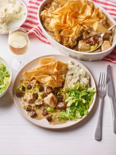 Chicken, mushroom, and leek pie with flaky phyllo crust, served with mashed potatoes, cabbage, and white wine.