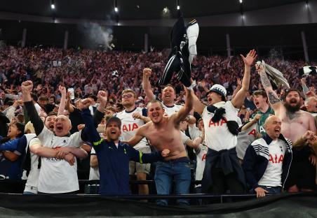 Jubilant Tottenham Hotspur fans celebrating a victory.
