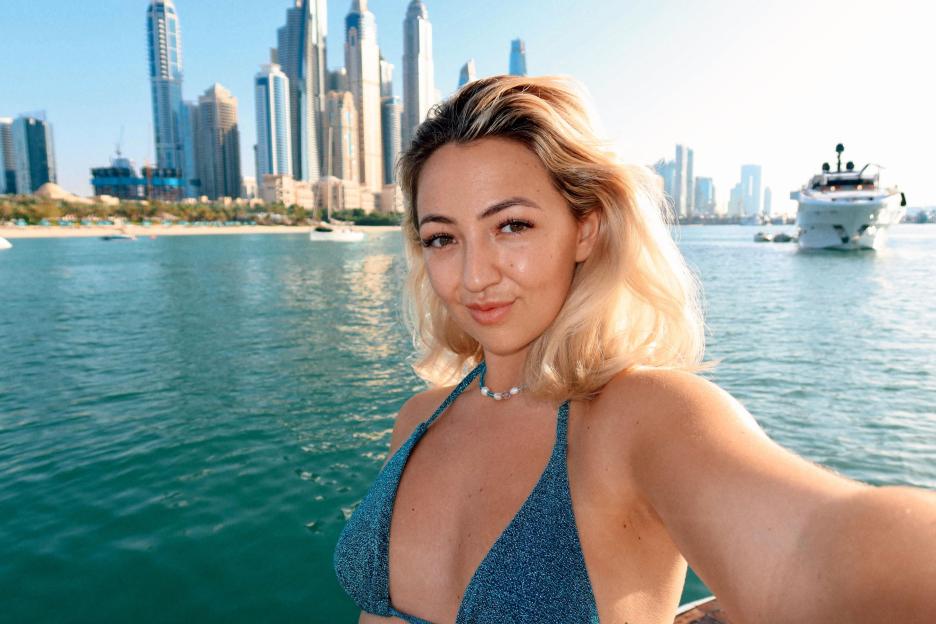 Woman in bikini taking selfie in Dubai.