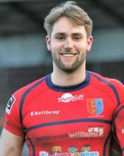 Portrait of a rugby player in a red jersey.