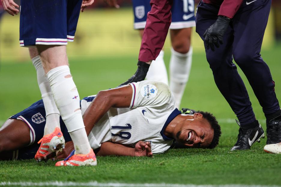 Ollie Watkins of England grimacing in pain on the ground with an injury.