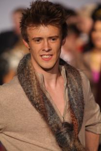 Ruari Cannon walking a runway at a fashion show.