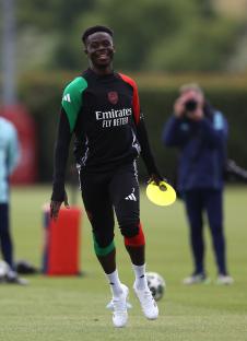 Bukayo Saka of Arsenal smiles during a training session.