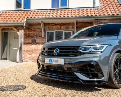Gray Volkswagen Tiguan parked in front of a house.