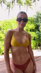 Frankie Bridge in a yellow bikini top and terracotta bikini bottom.