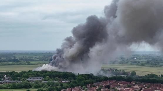 Large plume of black smoke rising from a fire at Bicester Motion.