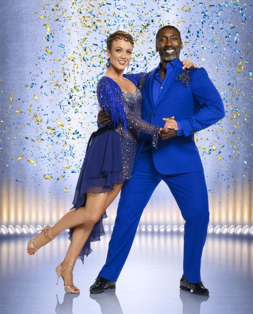 Lauren Oakley and Jimmy Floyd Hasselbaink posing together.