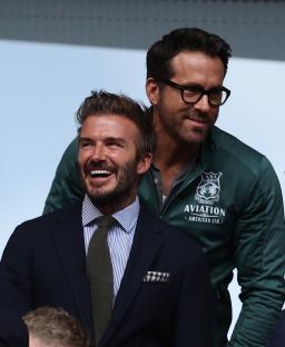 David Beckham, Ryan Reynolds, and Will Ferrell at a soccer game.