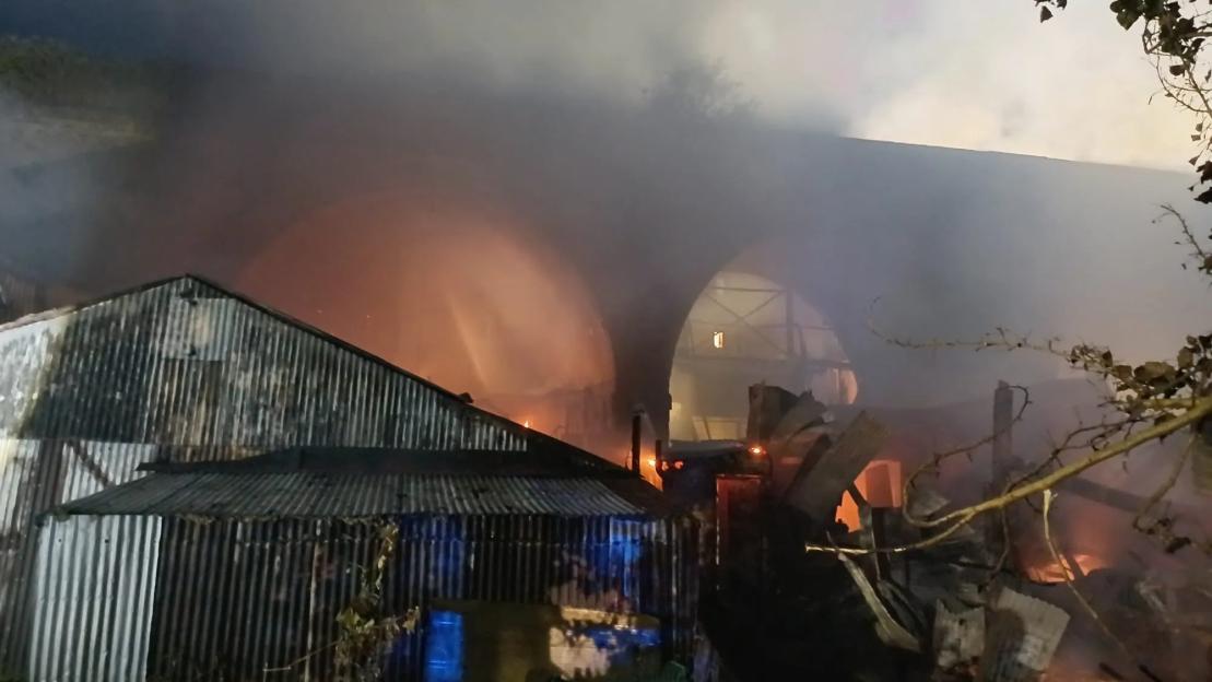 Huge fire erupts at railway arches with ‘gas cylinders exploding’ & smoke billowing through air sparking commuter delays
