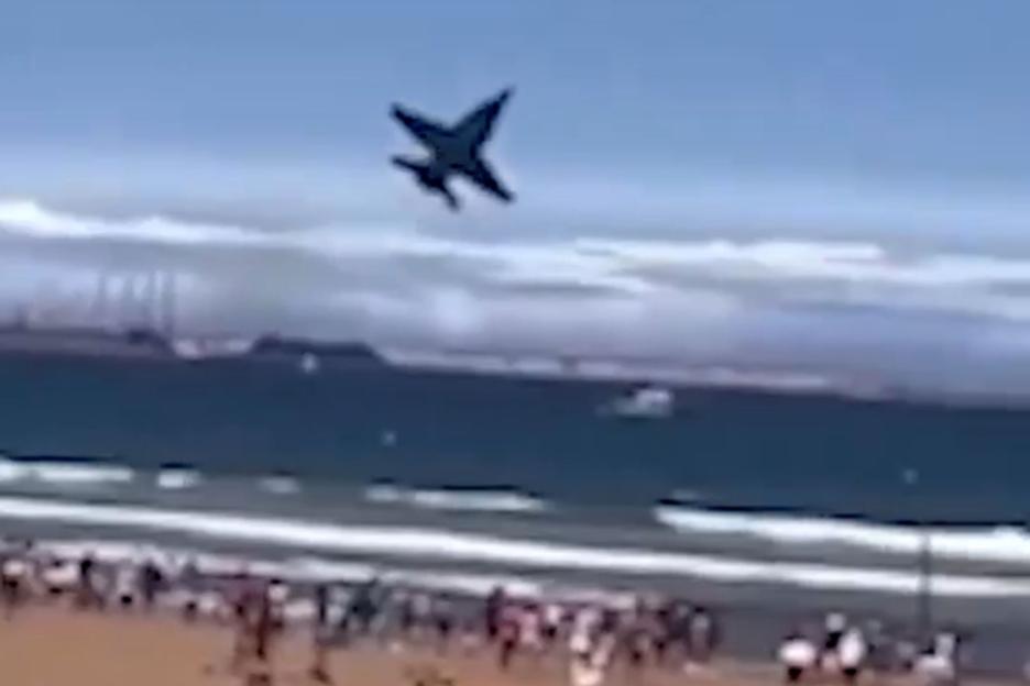 Terrifying moment tourists scream as fighter jet performs nail-biting low passes and aerobatics over Spanish beach