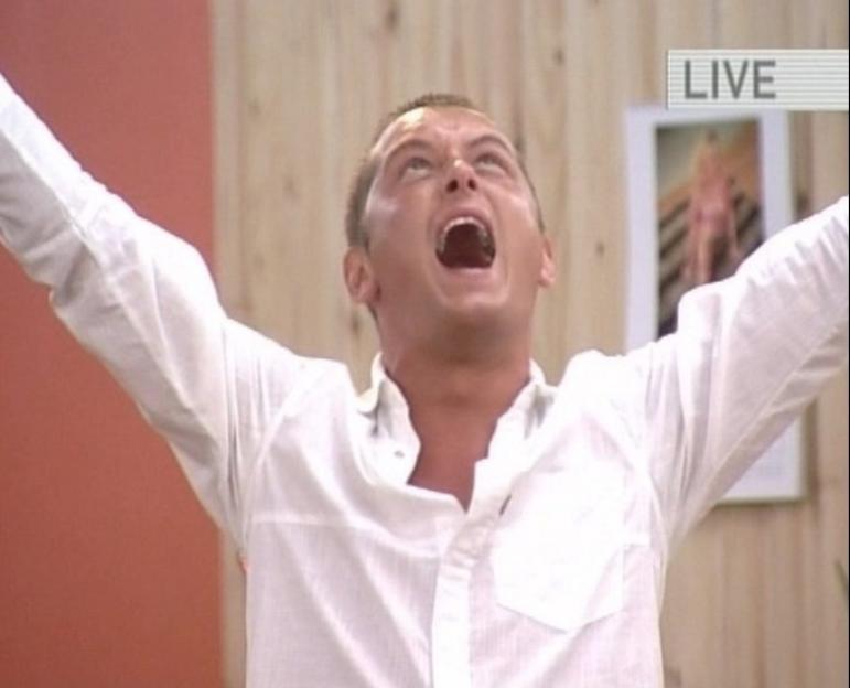 Brian Dowling, winner of Big Brother 2, raising his arms in triumph and shouting.